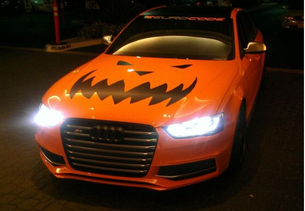 Orange Audi with pumpkin design on the hood