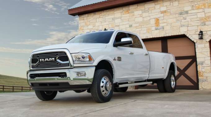 Recalled white Dodge Ram 3500 sits outside of a garage