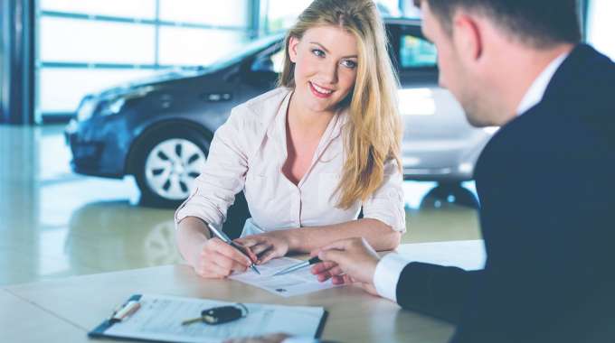 Woman refinancing car loan for a better rate and monthly payment