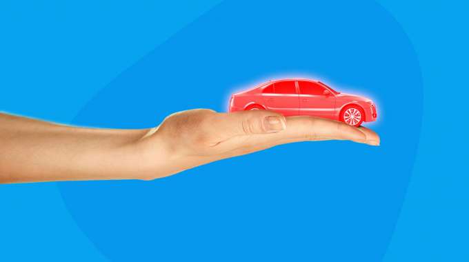 Hand holding a financed car for trade in